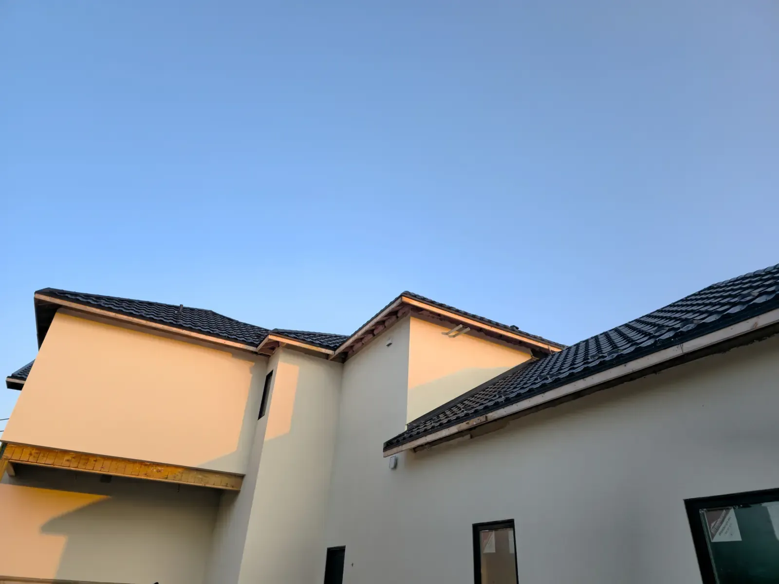 Cream stucco two-storey home with clean rooflines