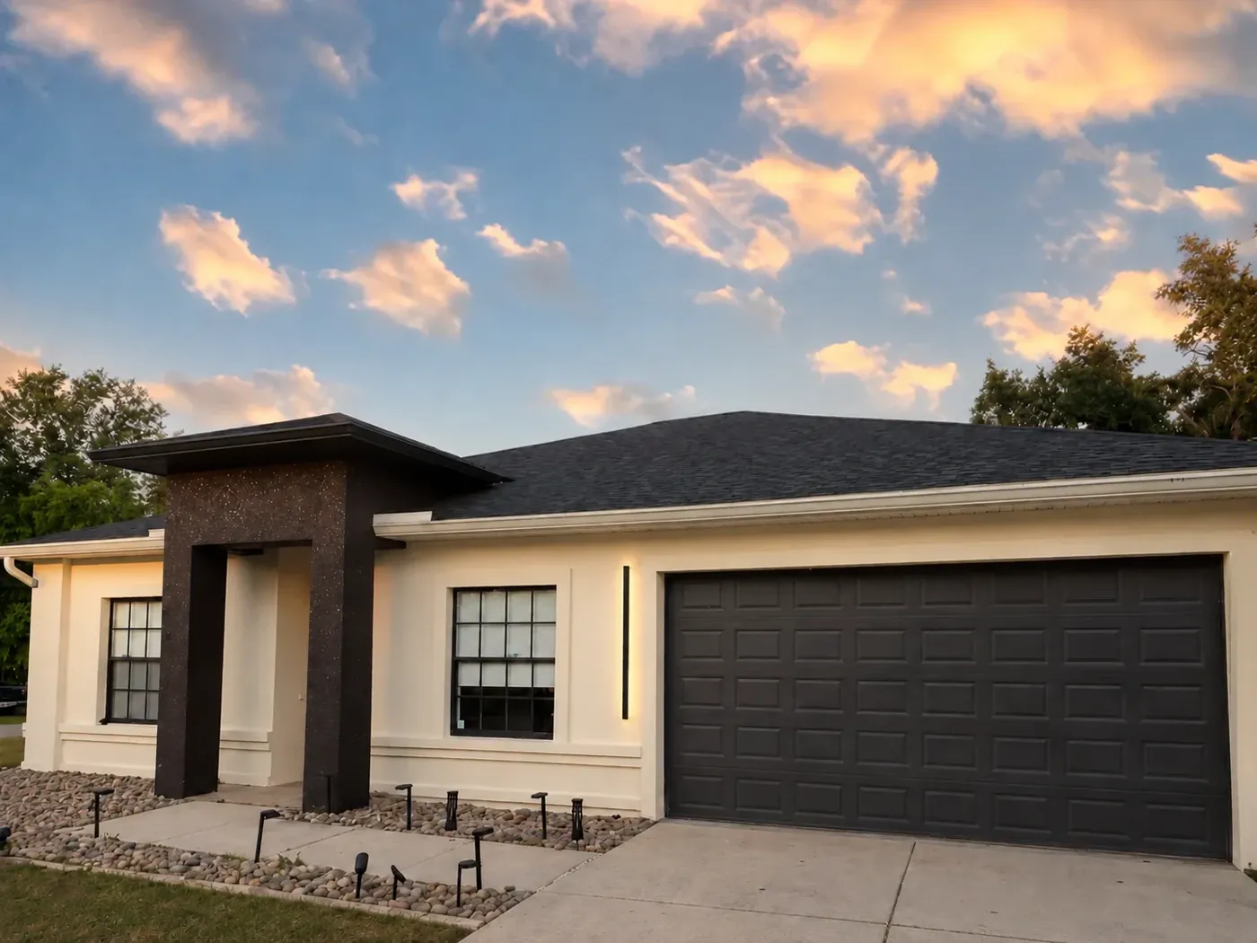 Single-storey home after a stucco recoat with a new entry column