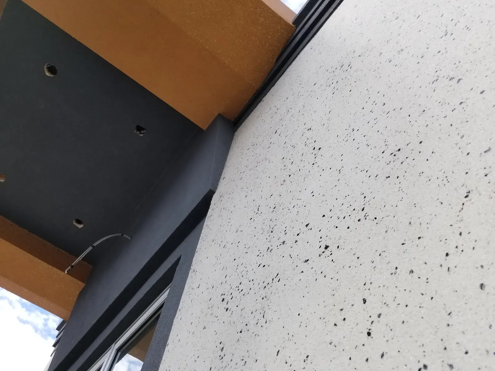 Close-up of textured stucco finish under a soffit